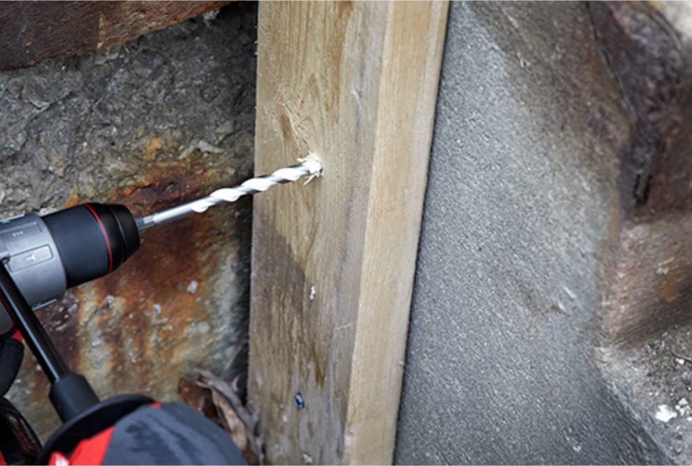 using a wooden slab with anchors,